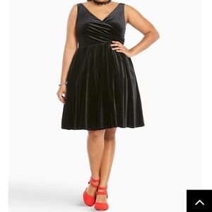 Torrid sleeveless black velvet surplice dress.